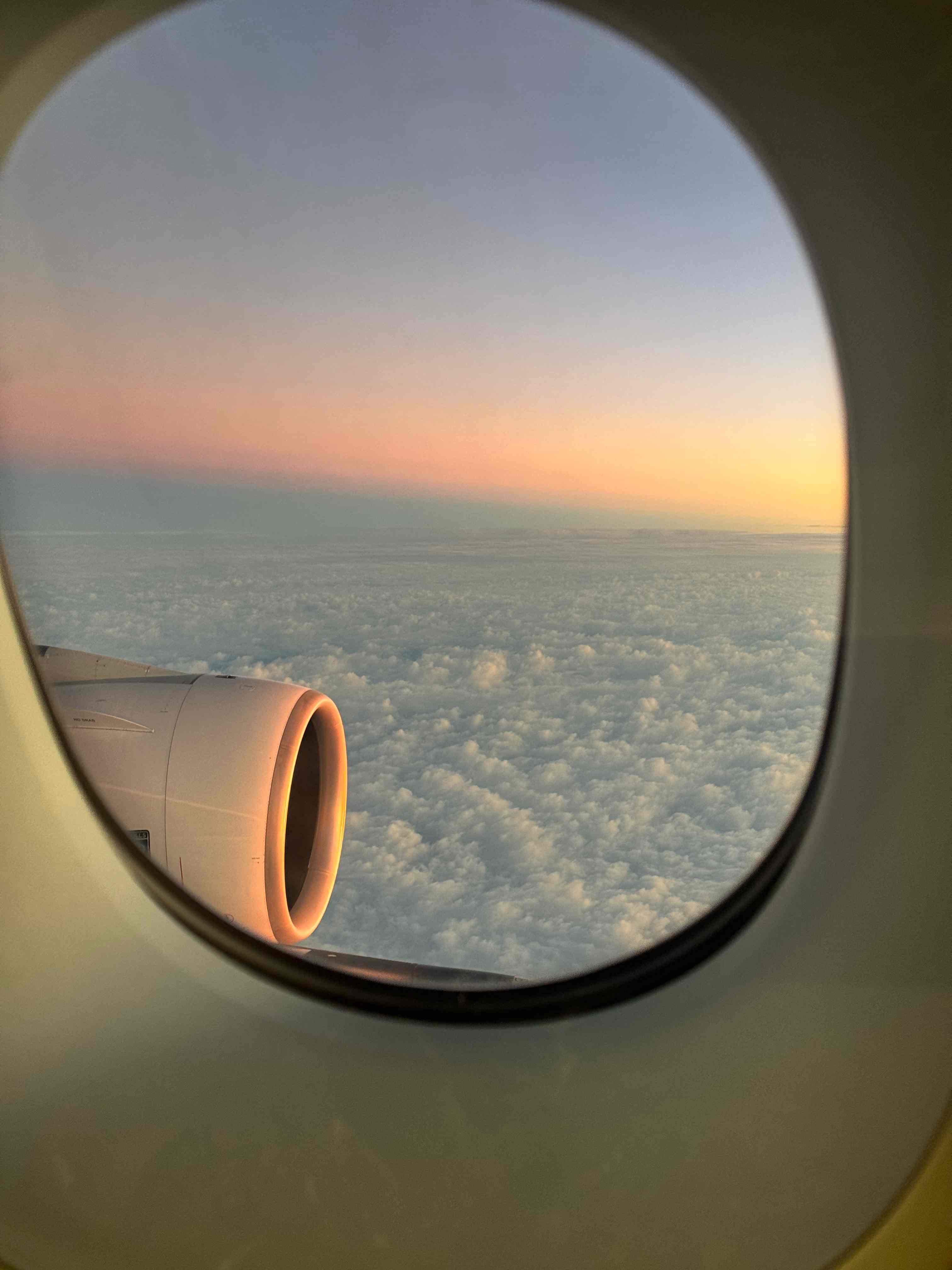 Sea of clouds and sunset outside the airplane window